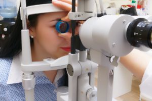 optometrist checking patient's eyes