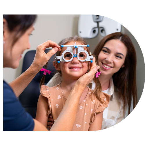 A child with her mother taking Pediatric Eye Exam